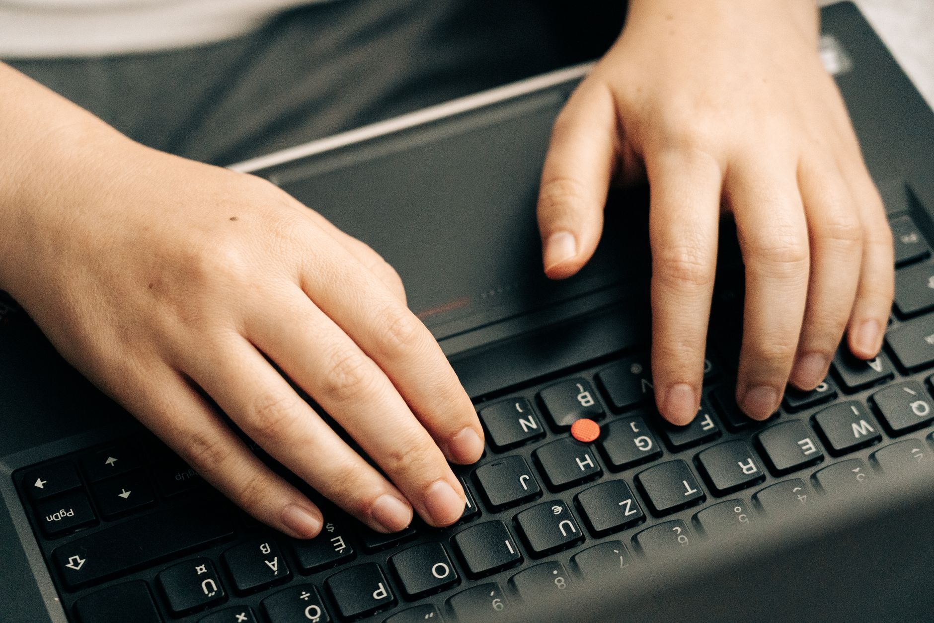 Unlock Peak Performance: The Best Mechanical Keyboards for 2026 2 A person's hands typing on one of the best mechanical keyboards with RGB lighting.
