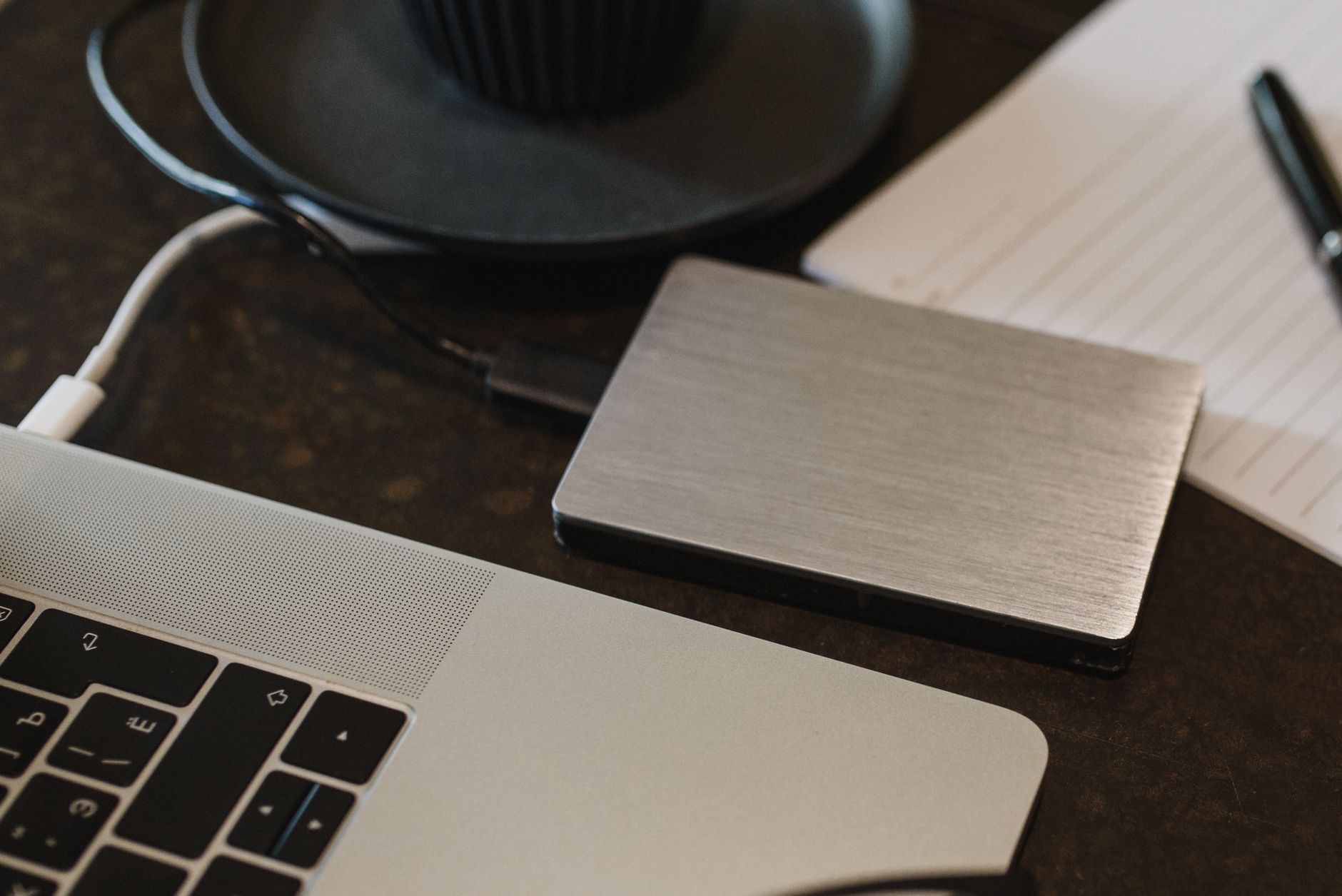 A sleek portable SSD connected to a laptop, representing the best portable SSD for fast data transfer.