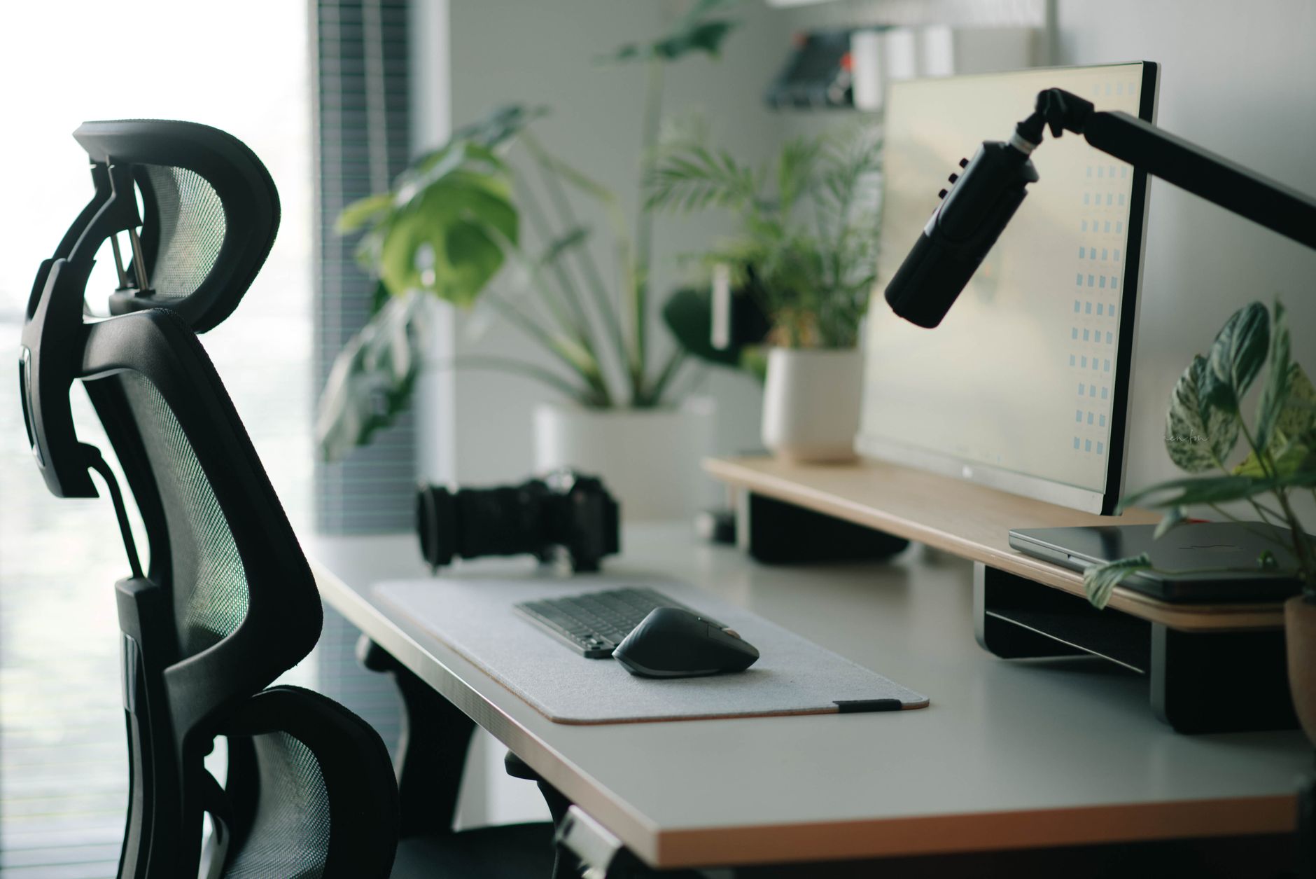 Elevate Your Workspace: Best Standing Desk Converters for 2026 2 A person happily working at a desk using one of the best standing desk converters for improved posture.