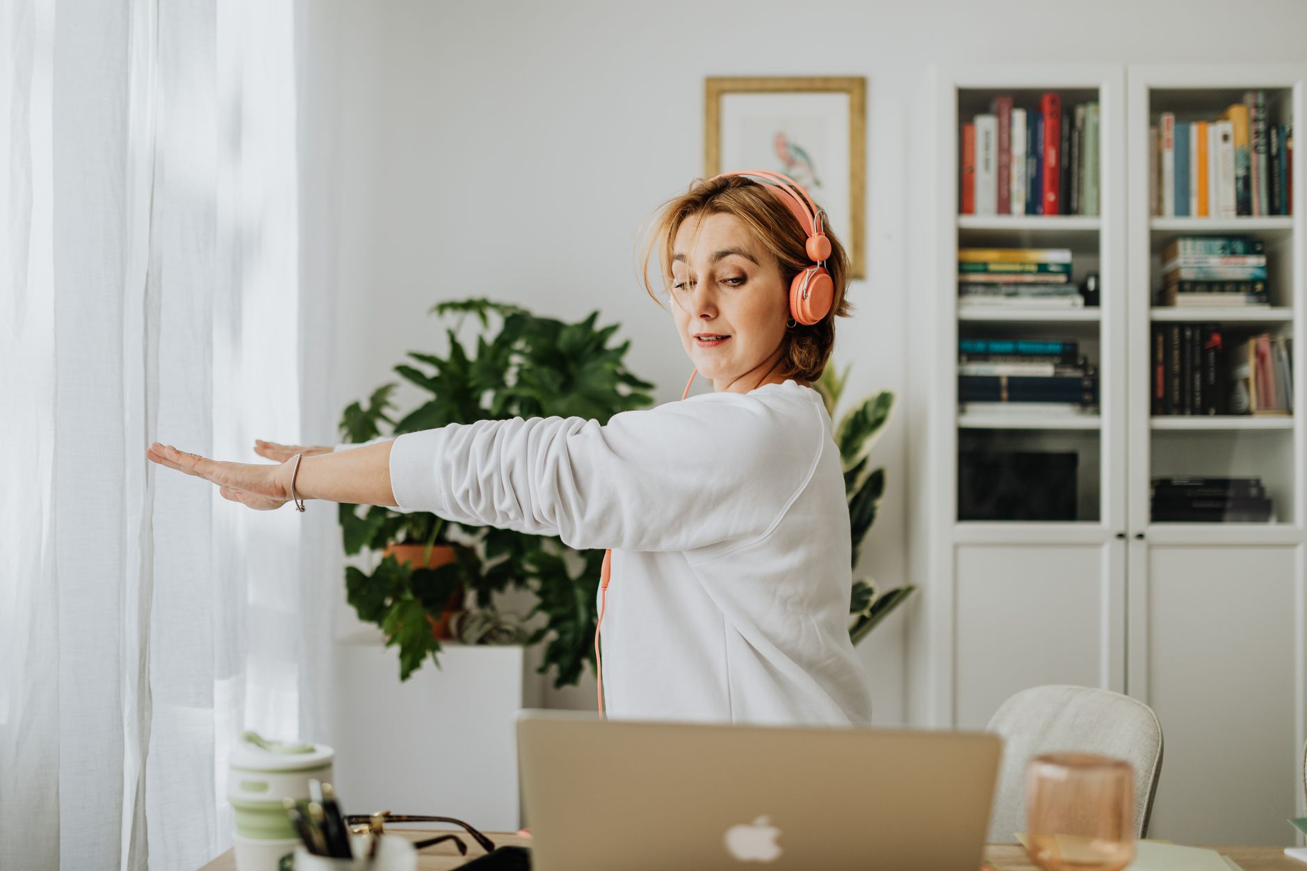 Elevate Your Workspace: Best Standing Desk Converters for 2026 9 A person taking a quick stretch break at their desk, illustrating the benefits of an active workstation.