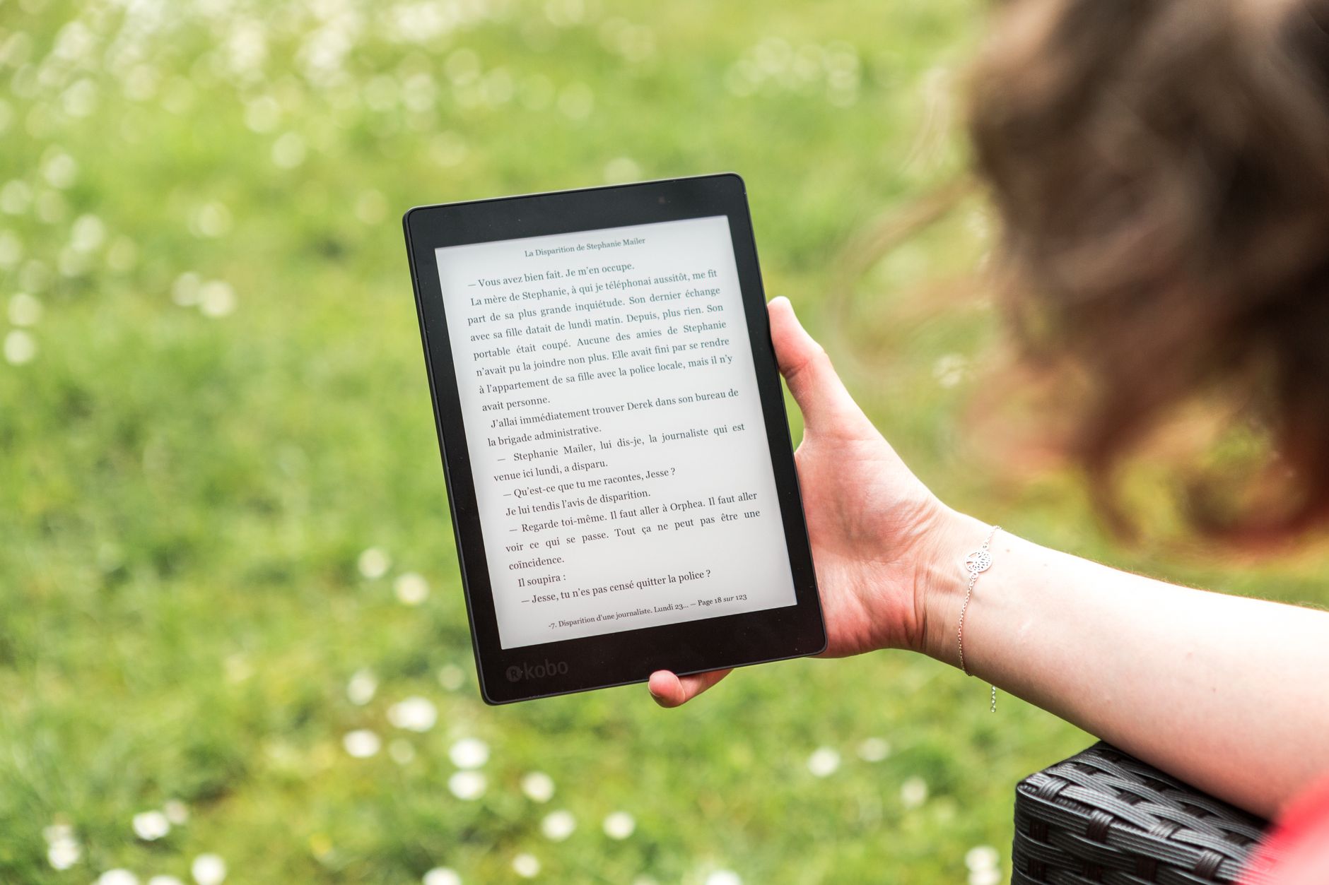 The Best E-Readers for 2026: Your Ultimate Digital Library 9 A person comfortably reading an e-reader in an outdoor setting