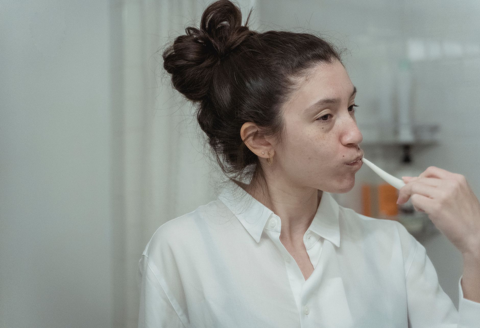 A person using one of the best electric toothbrushes for a clean smile