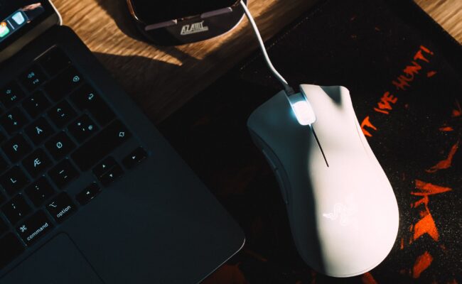 A close-up of a high-performance best gaming mice on a mouse pad with RGB lighting.