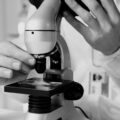 A researcher adjusting one of the best microscopes in a modern laboratory setting