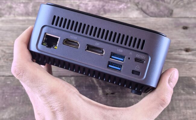 Unleash Power, Save Space: The Best Mini PCs of 2026 51 A sleek desk setup featuring one of the best mini PCs, showing its compact size next to a monitor.