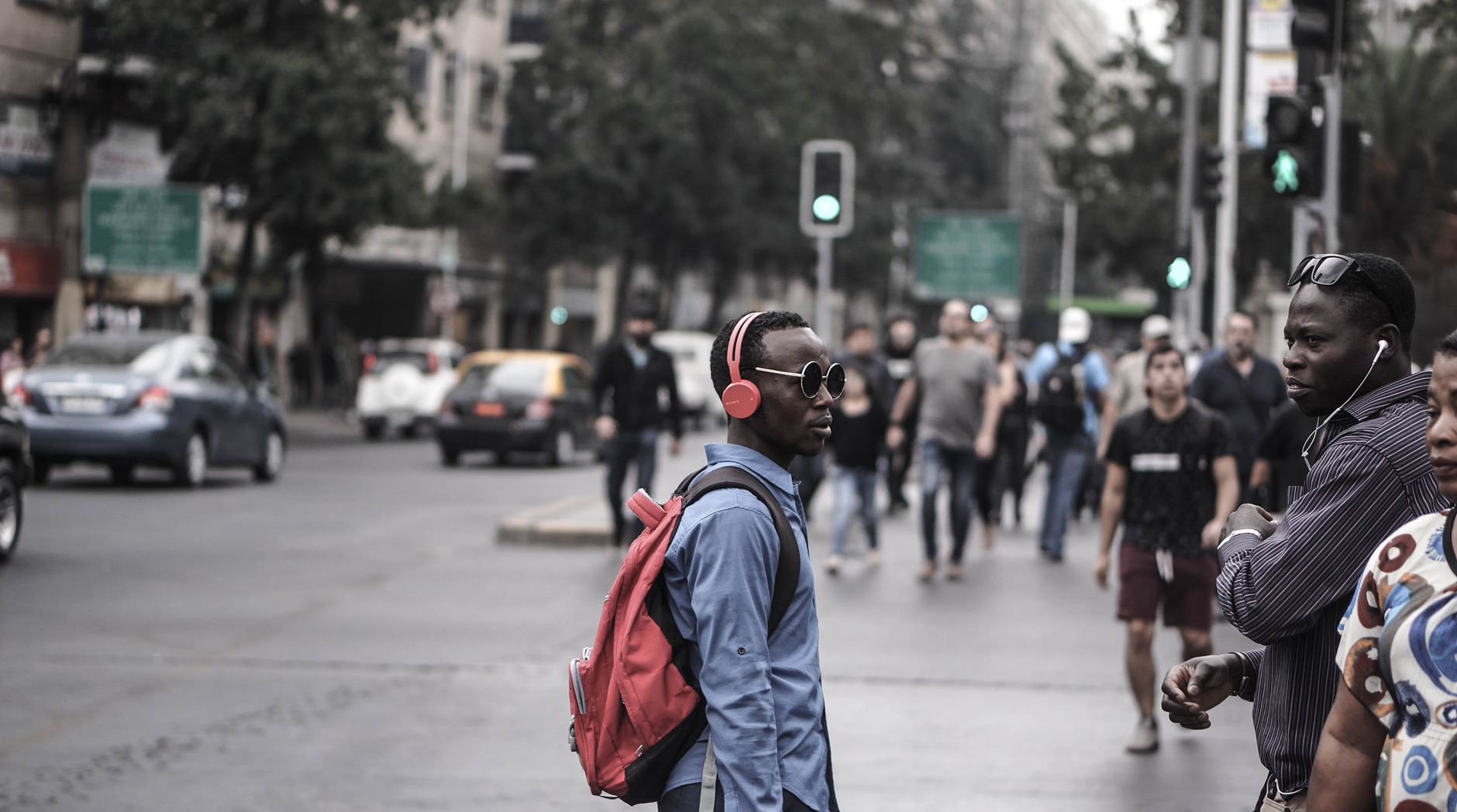 Tune Out the World: Best Noise Cancelling Headphones for 2026 6 Man walking through a busy city street wearing noise cancelling headphones
