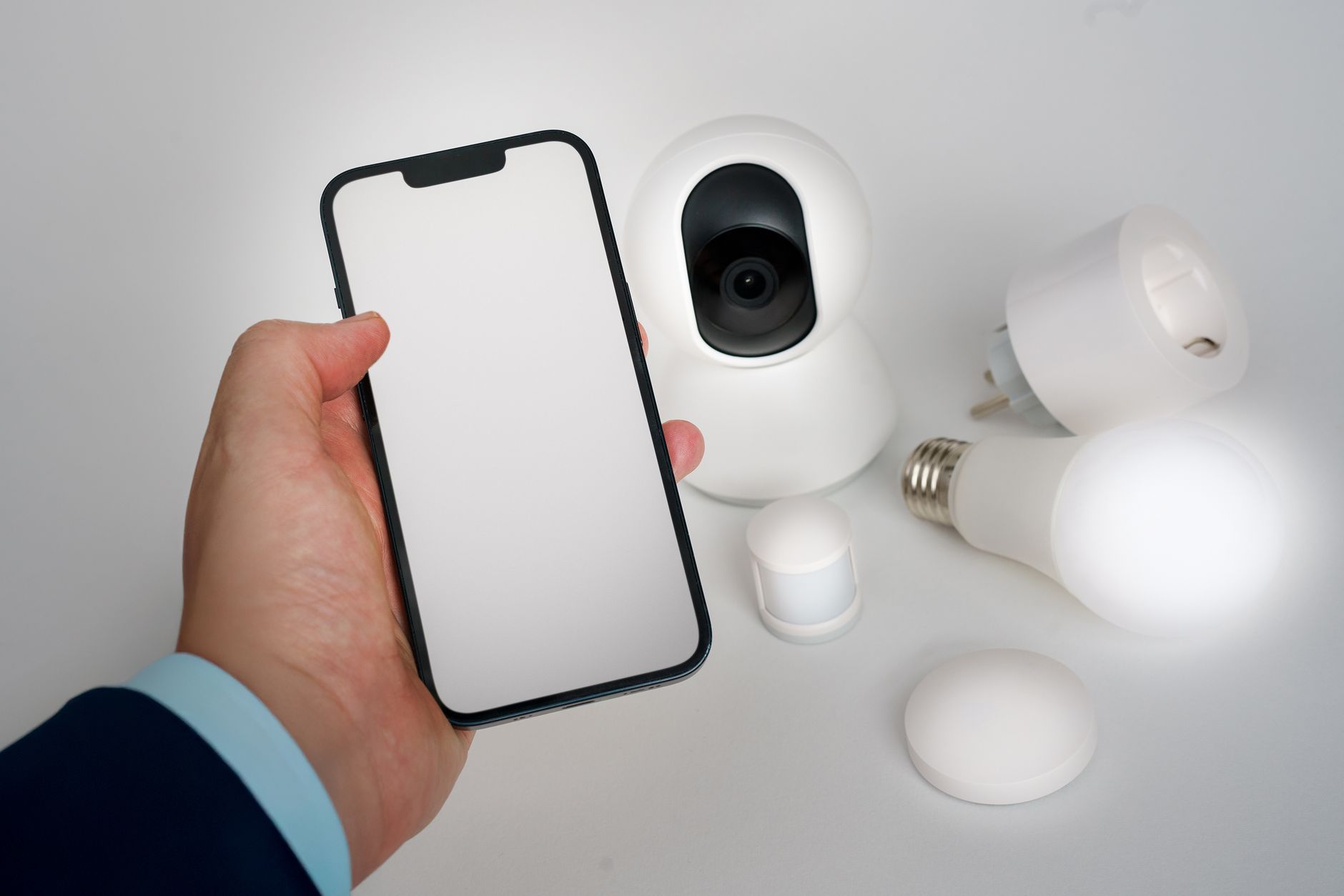 Light Up Your Life: The Best Smart Bulbs for 2026 9 Woman adjusting smart home lighting with a tablet