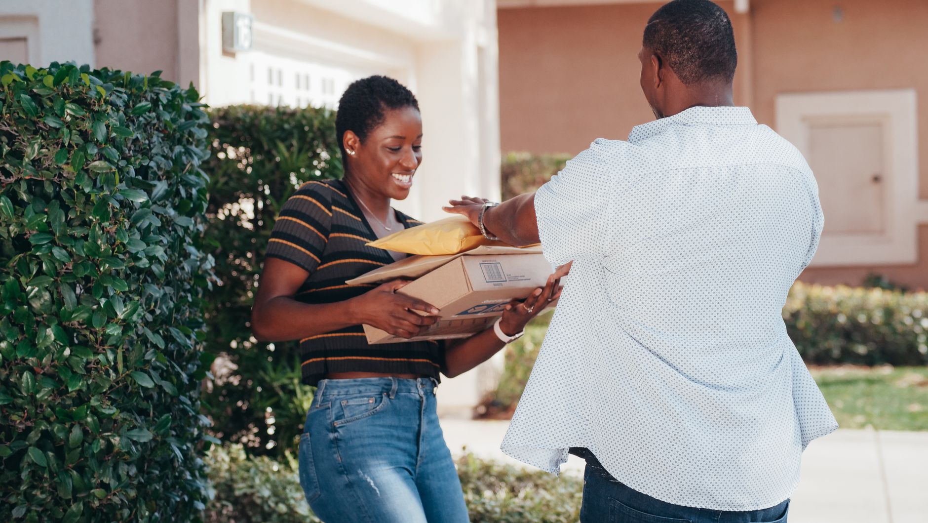 Unlock Your Home's Security: Best Smart Doorbell Cameras for 2026 3 A delivery person leaving a package at a front door, monitored by a smart doorbell.