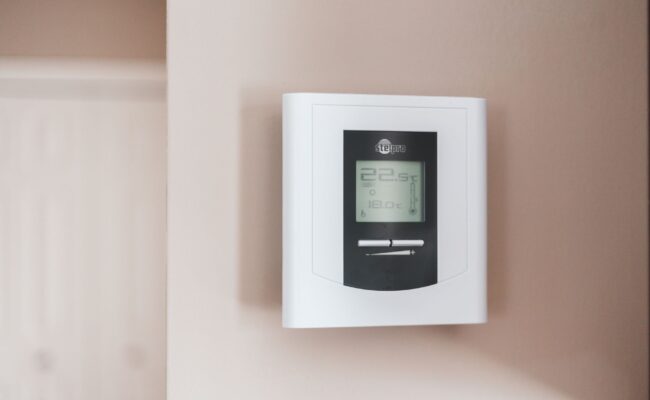 Upgrade Your Home Comfort: Best Smart Thermostats for 2026 1 A sleek smart thermostat on a wall, demonstrating the best smart thermostats for 2026.