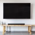 The Best Soundbars for 2026: Elevate Your Home Audio Experience 29 A modern living room featuring a sleek soundbar beneath a large television, showcasing the best soundbars for an immersive audio experience.