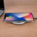 The Best Wireless Chargers for 2026: Power Up Your Devices 22 A smartphone wirelessly charging on one of the best wireless chargers on a modern desk.