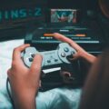 A person intently playing on one of the best handheld gaming consoles.