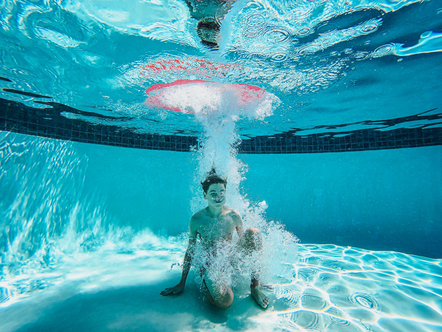 Best Portable Bluetooth Speakers Under $100 for 2026 3 Waterproof portable speaker sitting next to a swimming pool