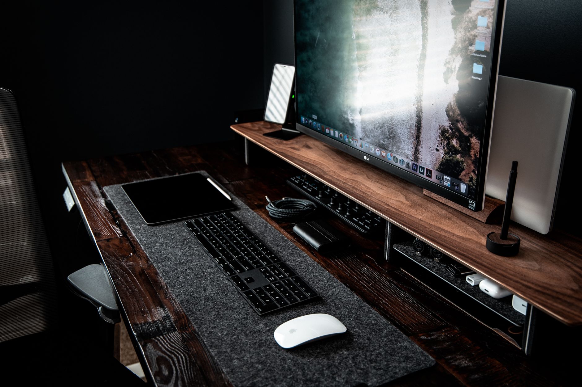 A sleek portable monitor connected to a laptop in a modern office.