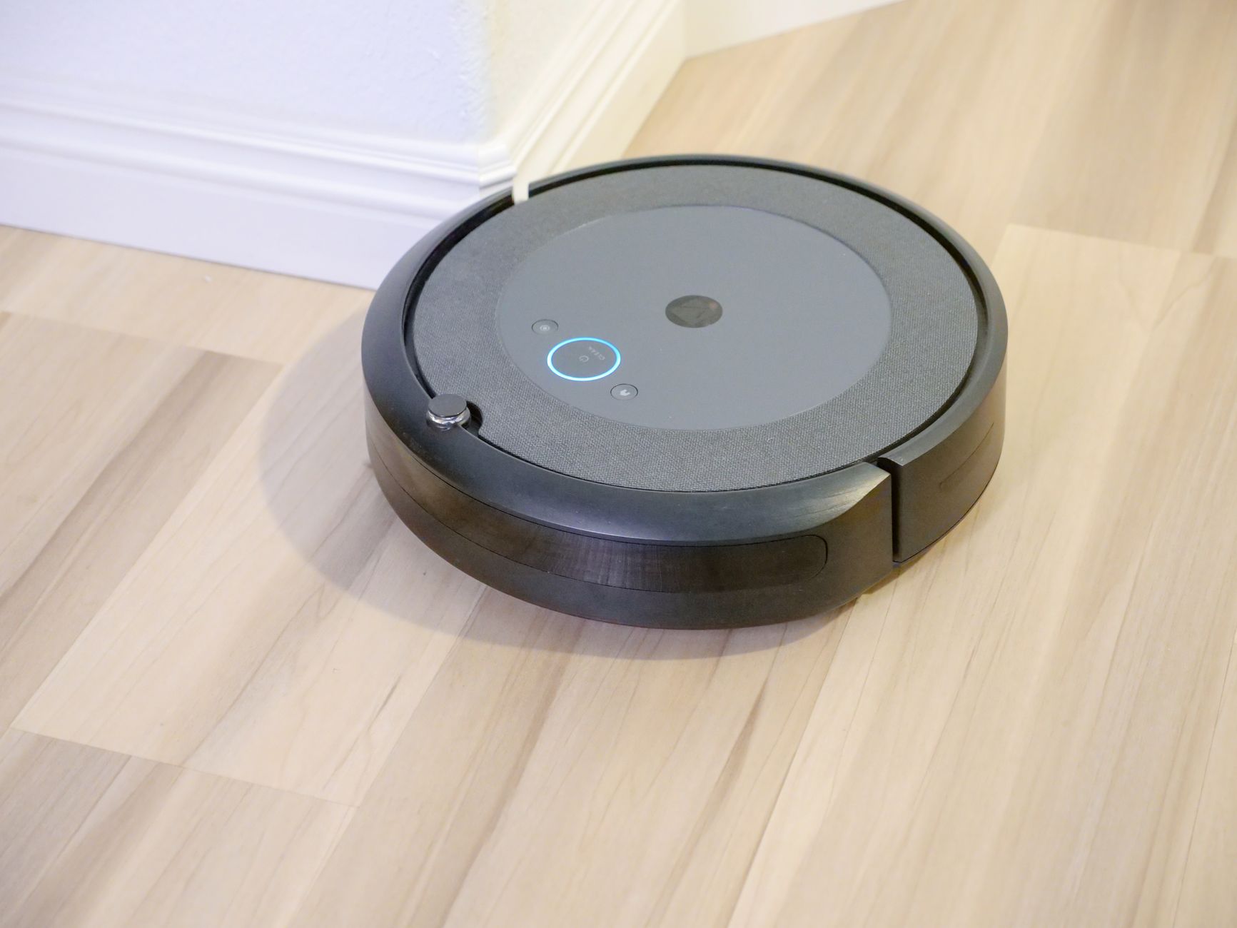 A robot vacuum and mop cleaning a living room floor