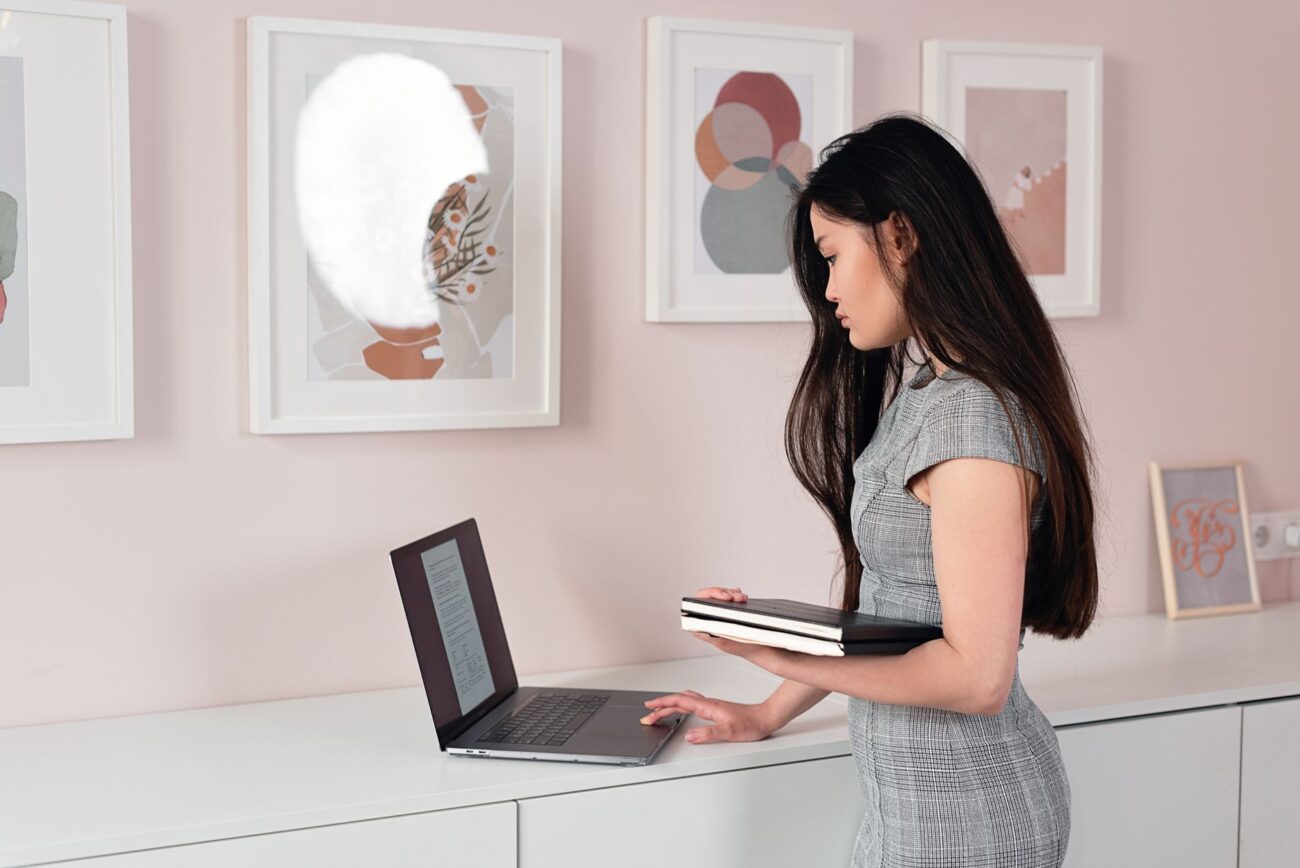 Elevate Your Workspace: Best Standing Desk Converters for 2026 1 A person happily working at a desk using one of the best standing desk converters for improved posture.