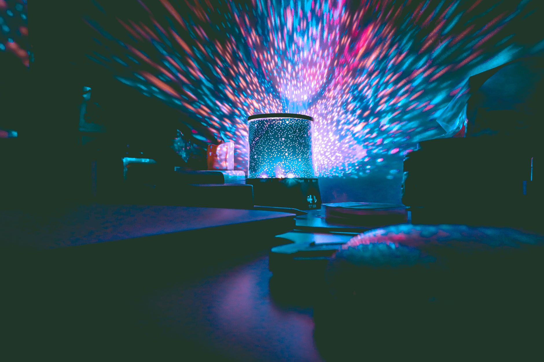 Shine Bright: The Best Star Projectors for 2026 Revealed 2 A cozy bedroom illuminated by a vibrant star projectors display.