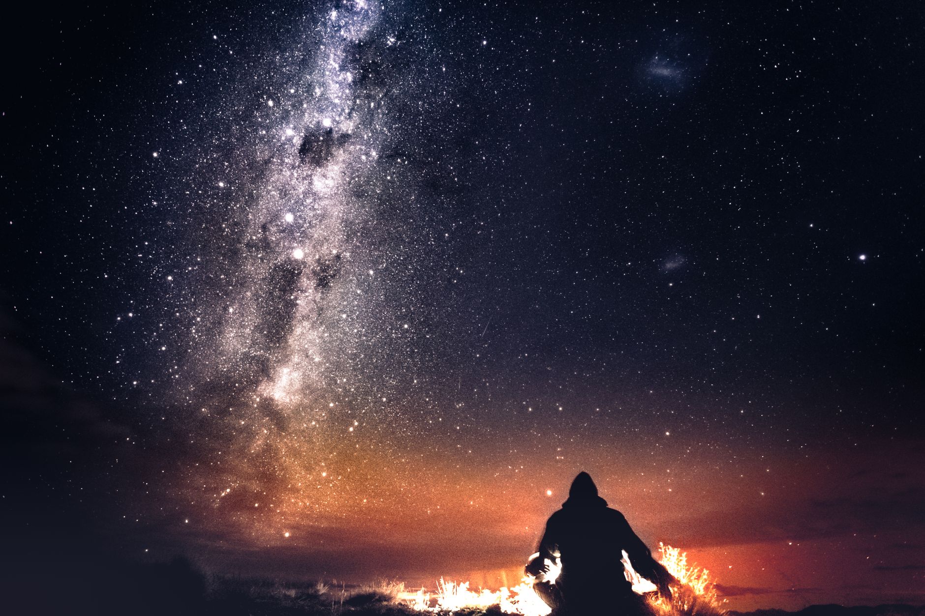 Shine Bright: The Best Star Projectors for 2026 Revealed 9 Person relaxing under a projected starry sky in a dark room.