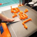 A close-up of a desktop 3D printer in action, ideal for 3d printers for beginners.