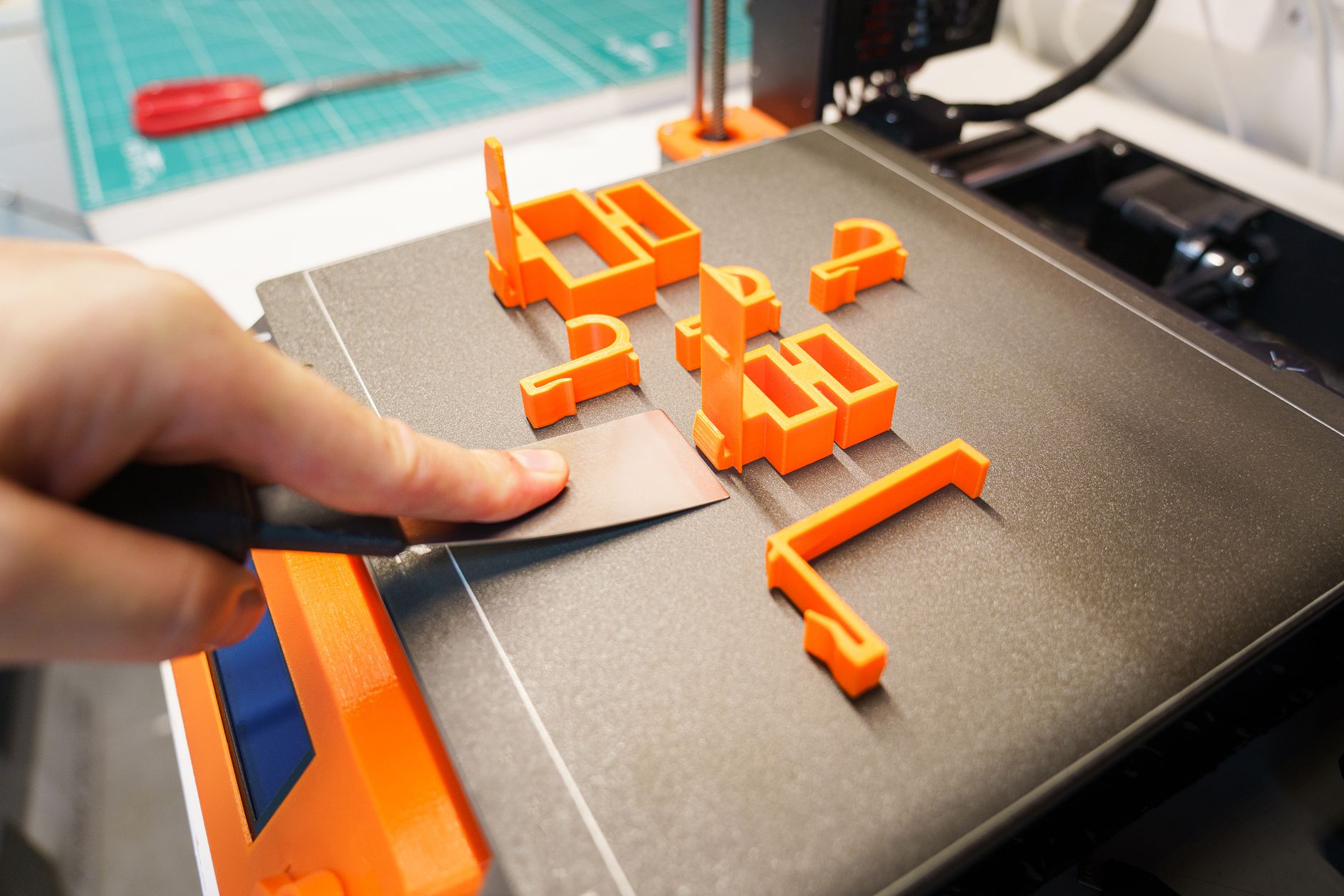 The Best 3D Printers for Beginners in 2026: Your Ultimate Guide 3 Various colorful 3D printed objects on a table.