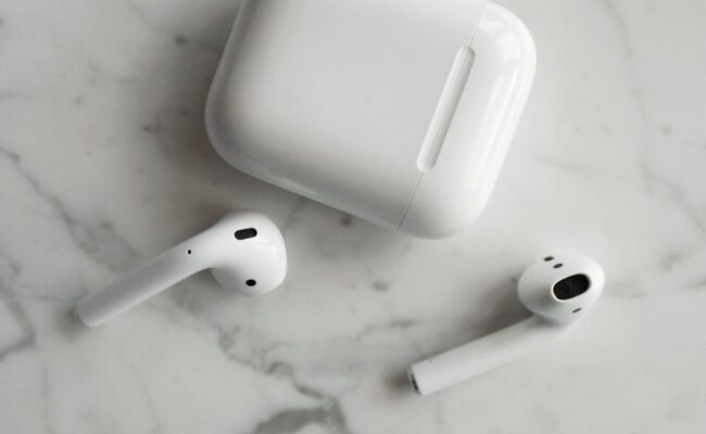 AirPods Ultra Reportedly Set for Launch Next Month 3 person wearing wireless earbuds during airpods ultra launch news