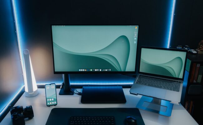 A person focused on their work at a desk with the best 4K monitors for productivity