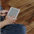 A person comfortably reading on one of the best e-readers with a vibrant E Ink display.