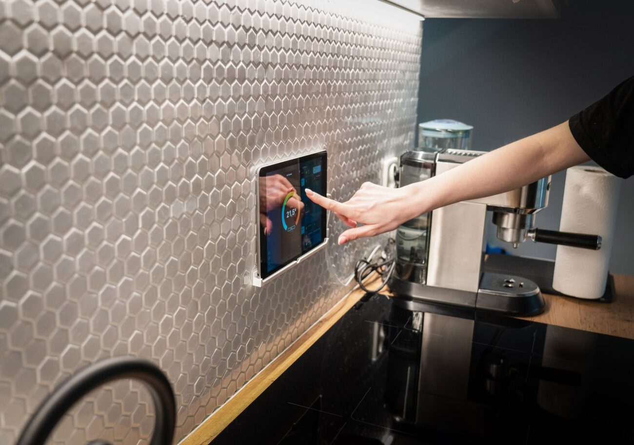 A sleek digital display of the best smart thermostats in a modern home.