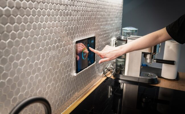 A sleek digital display of the best smart thermostats in a modern home.