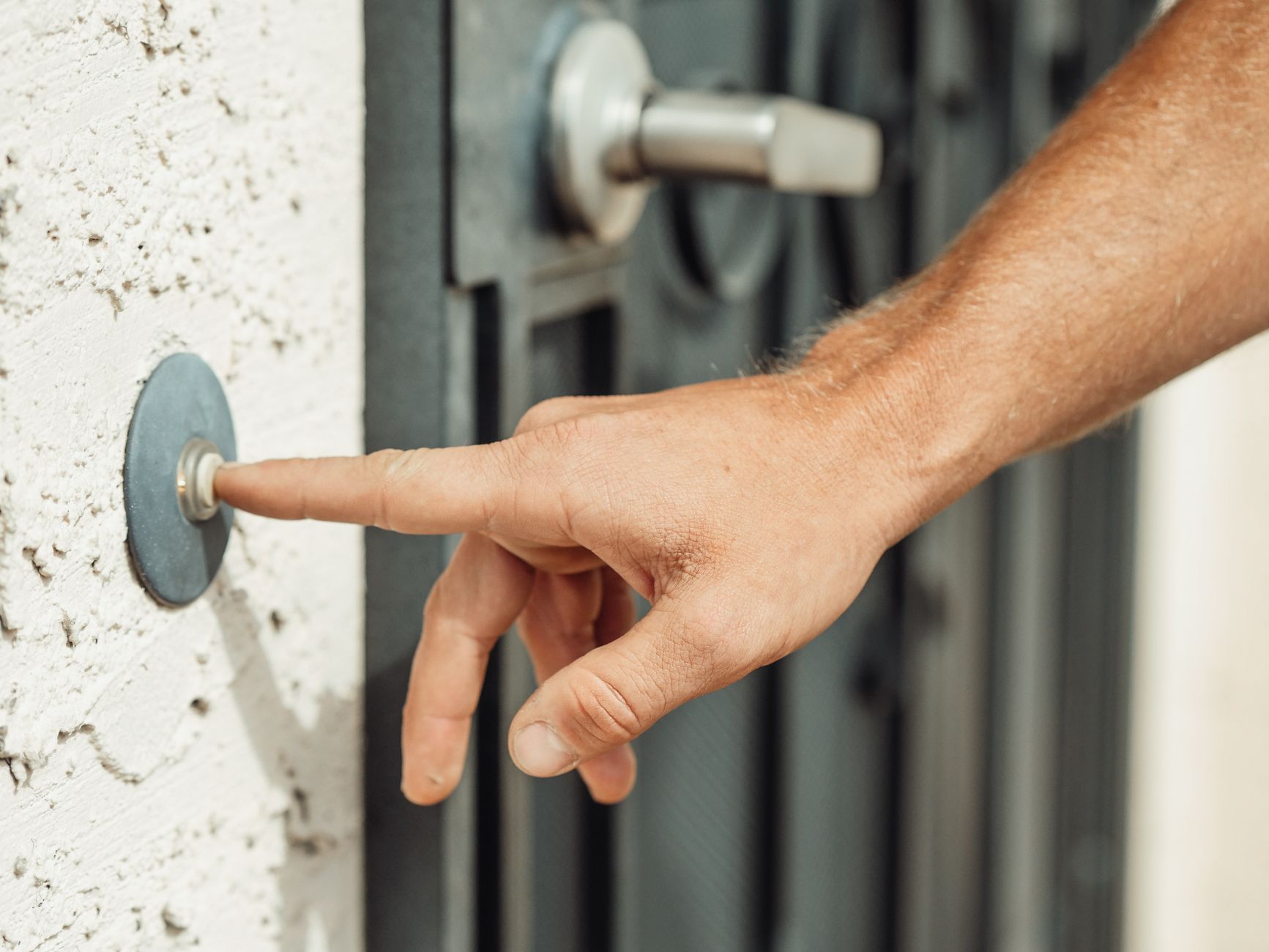The Best Video Doorbells for 2026: Smart Security for Your Home 2 A person's hand pressing a button on one of the best video doorbells