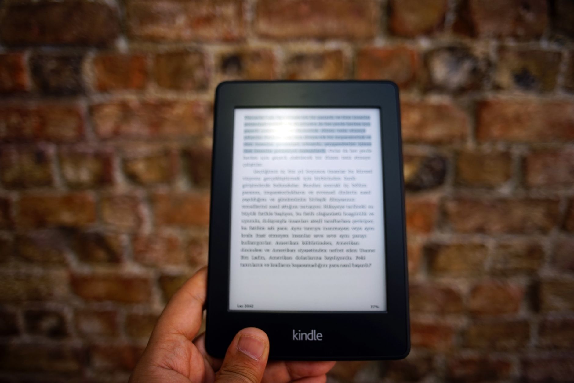 E-Reader vs Kindle: Which Device Fits Your Reading Style? 3 Hands holding a lightweight electronic book reader outdoors