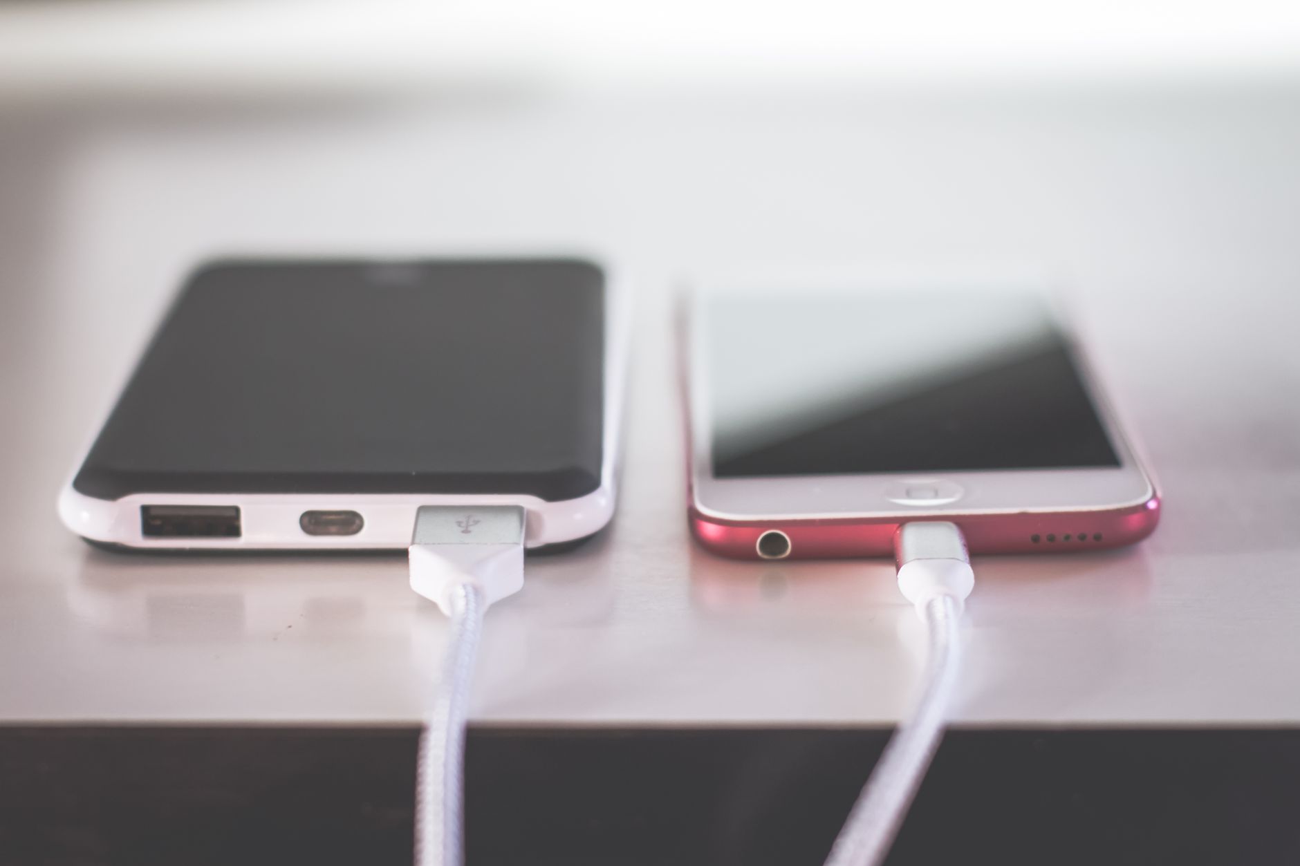 How to Fix a Wireless Charger That Stopped Working 2 Hands setting phone down to fix a wireless charger on a desk