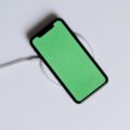 How to Fix a Wireless Charger That Stopped Working 17 Hands setting phone down to fix a wireless charger on a desk