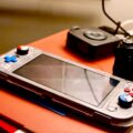 Handheld Gaming PC vs Laptop: Which Should You Buy for Portable Gaming? 16 A gamer enjoying a handheld gaming PC, comparing handheld gaming pc vs laptop.