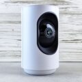 Ring Doorbell vs. Security Camera: Which Should You Buy? 12 A person standing at a front door with a ring doorbell vs security camera visible