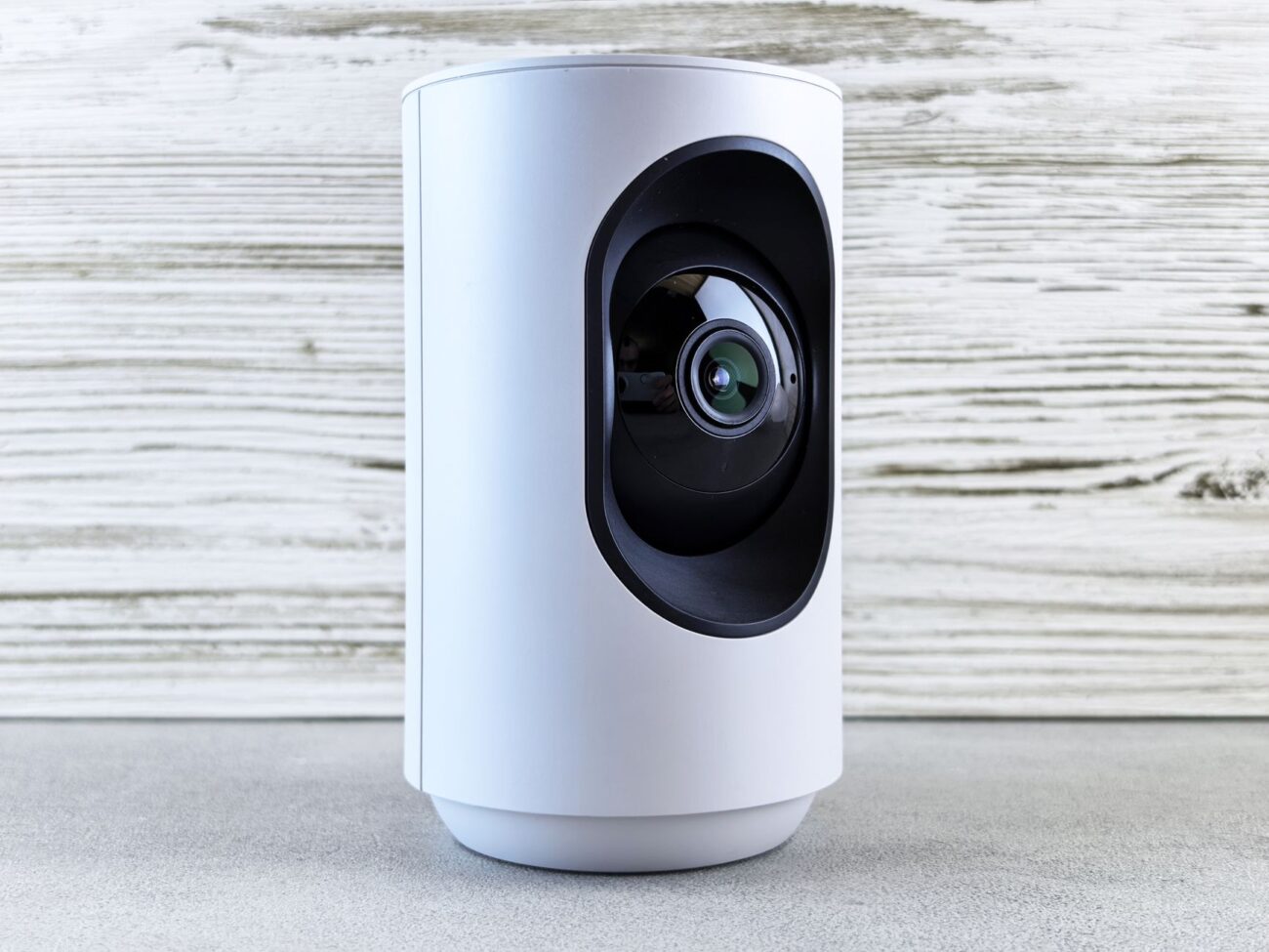 A person standing at a front door with a ring doorbell vs security camera visible