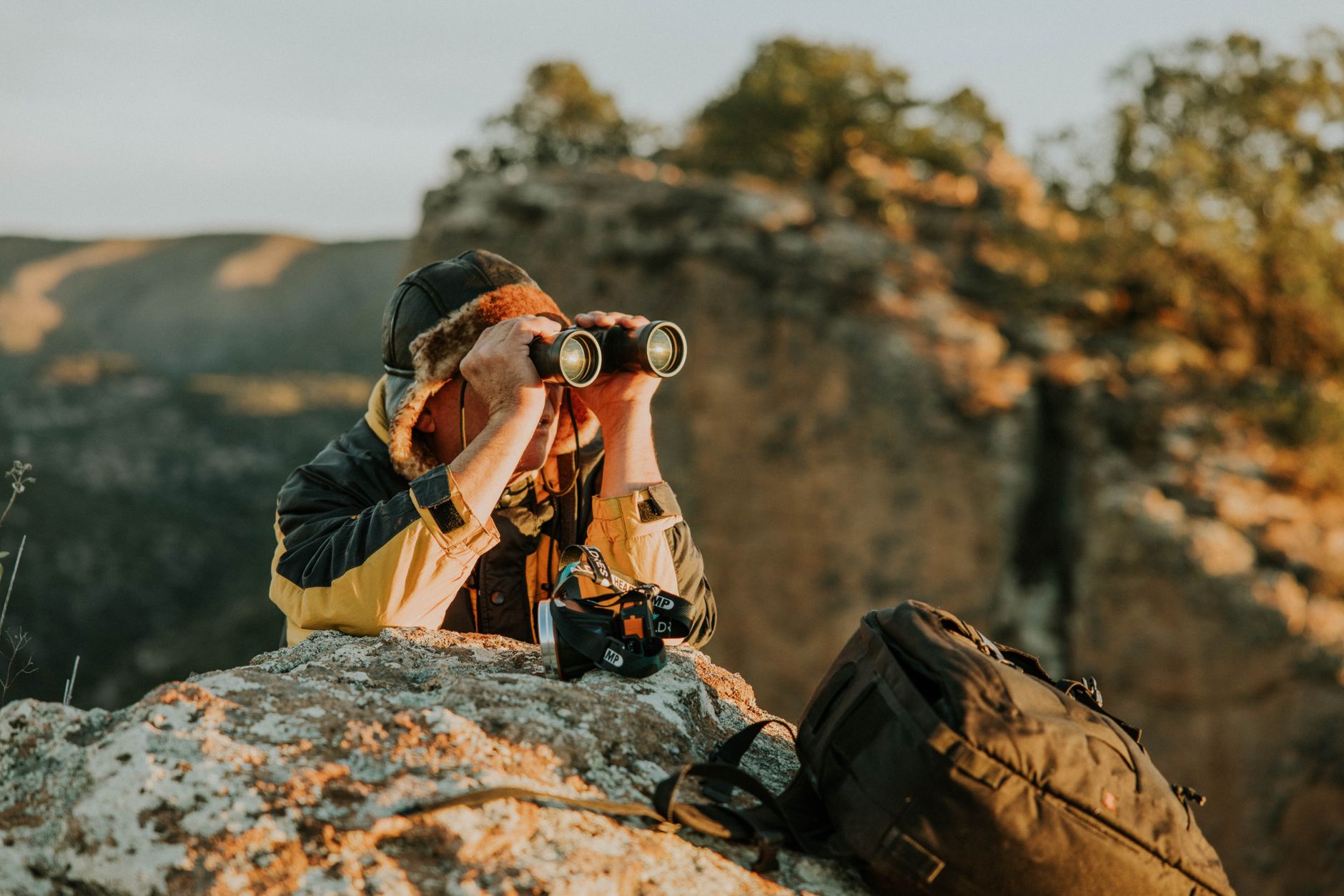 Telescope vs. Binoculars: Which Optics Should You Buy? 7 pair of binoculars resting outdoors