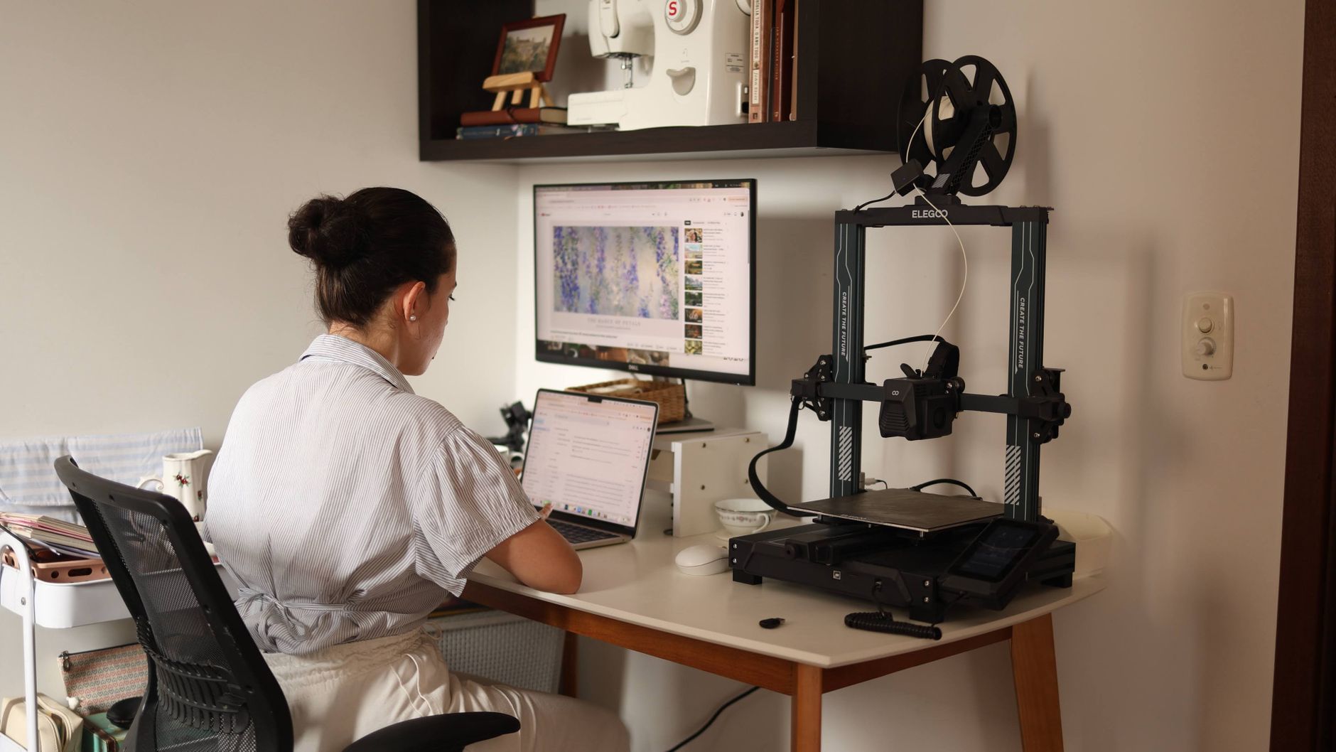 A person inspecting a model being created by one of the best 3d printers.