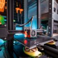 The Best 3D Printers for 2026: Unleash Your Creativity 10 A person inspecting a model being created by one of the best 3d printers.