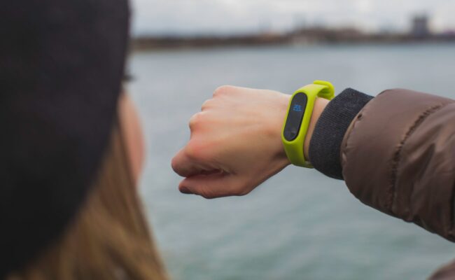 Fitness Tracker Not Tracking Steps? Here Is How to Fix It 2 Hands adjusting a wristband when a fitness tracker not tracking steps occurs