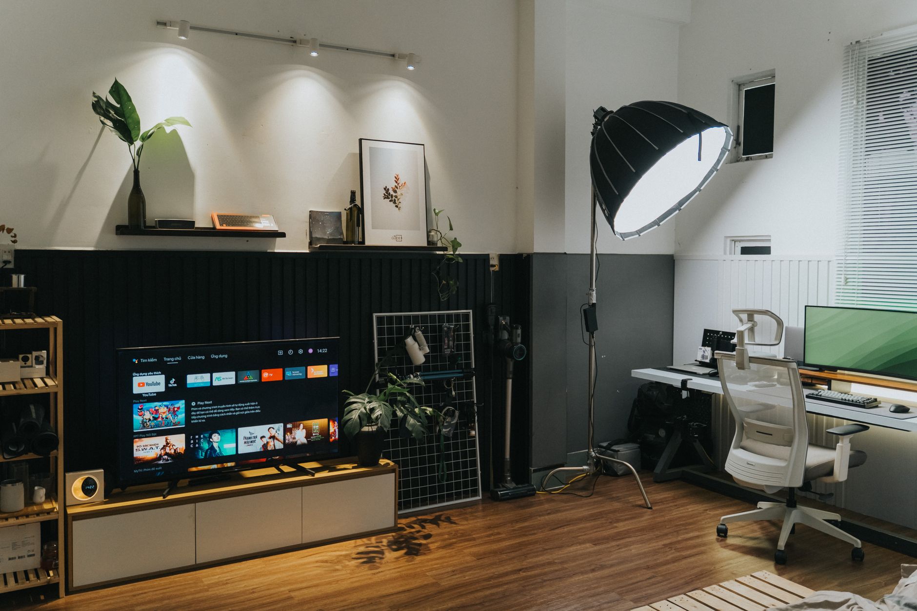 High end smart television mounted on wall in dimly lit room