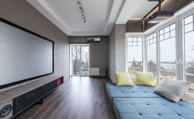 Projector vs. TV: Which Big Screen Display Should You Buy? 3 Comparing a modern home theater projector vs tv screen setup