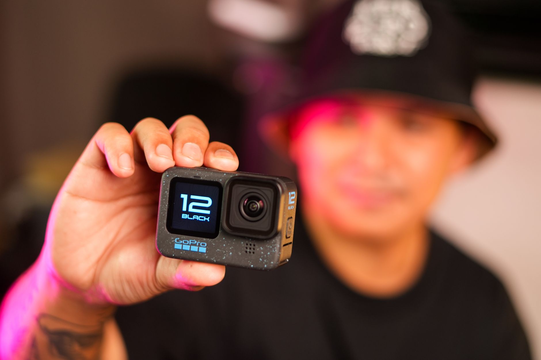 How to Set Up Action Camera Gear for Cinematic Video 2 Hands adjusting the touchscreen to set up action camera recording modes