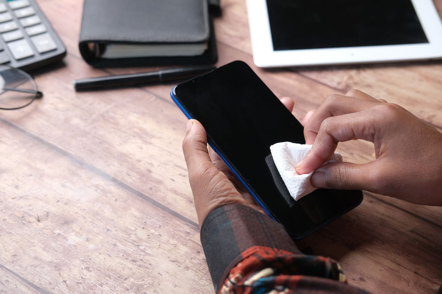 How to Fix a Smartwatch Rash and Prevent Wrist Discomfort 3 Cleaning the sensors and strap of a smartwatch with a microfiber cloth