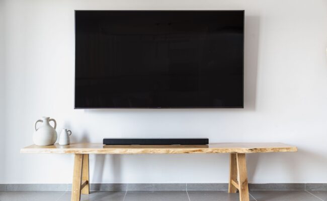 Modern living room entertainment center demonstrating soundbar vs. speakers setups