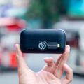 Power Bank vs Power Station: Which Should You Buy in 2026? 4 Person using a power bank to charge smartphone outdoors - power bank vs power station comparison