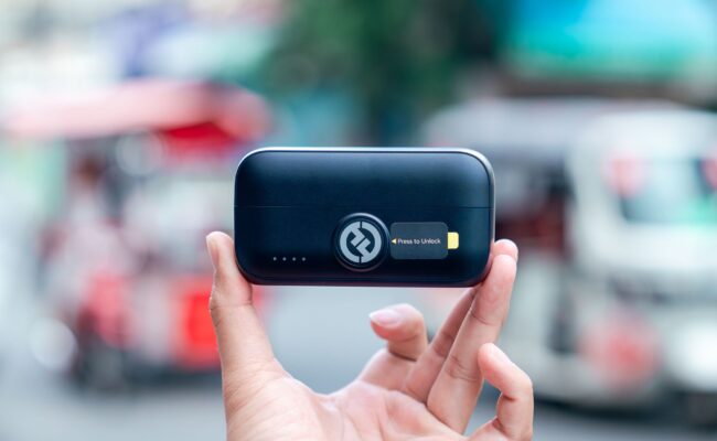 Power Bank vs Power Station: Which Should You Buy in 2026? 3 Person using a power bank to charge smartphone outdoors - power bank vs power station comparison